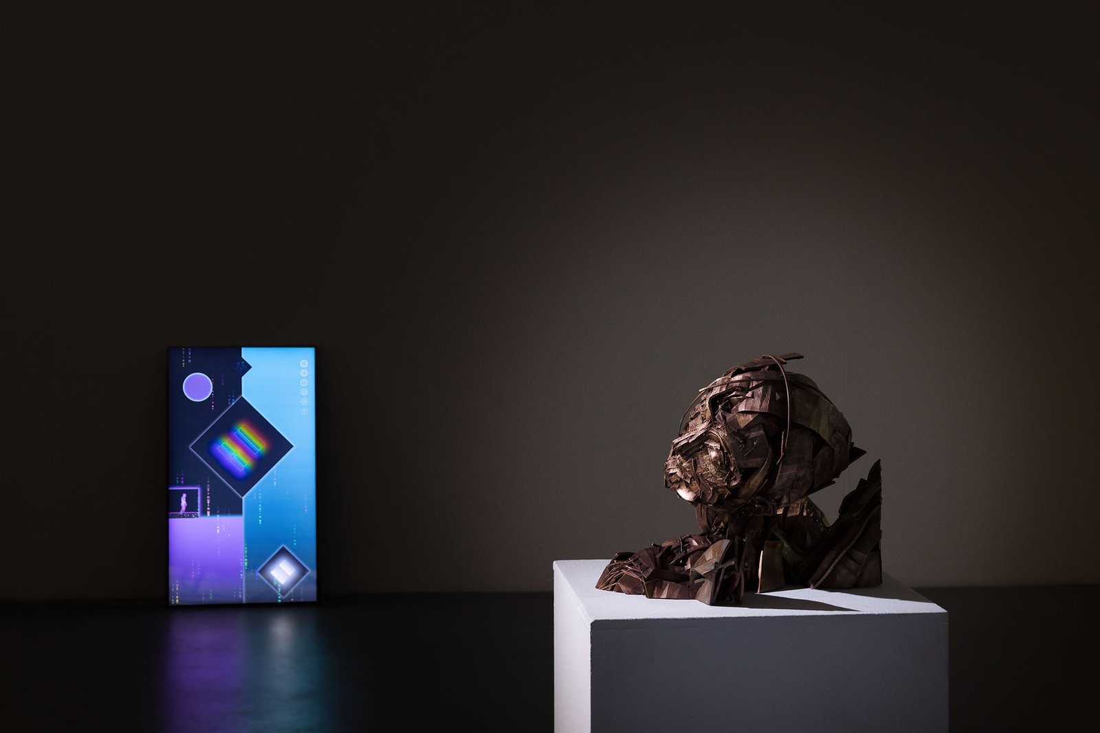 Bronze bust beside a luminous token screen